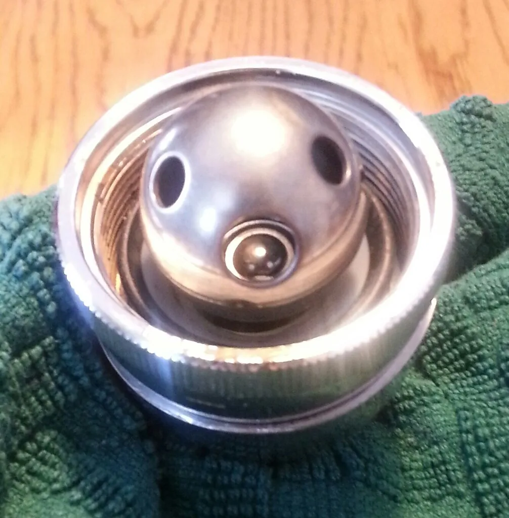 Kitchen faucet leak repair with water dripping from a faucet