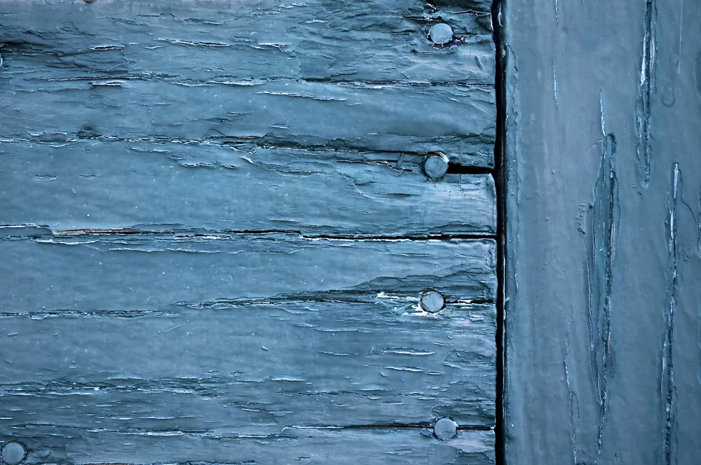 Peeling paint from moisture caused by caulk failure water intrusion